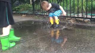 Kids splashing in puddles in rainboots [upl. by Ettenot]